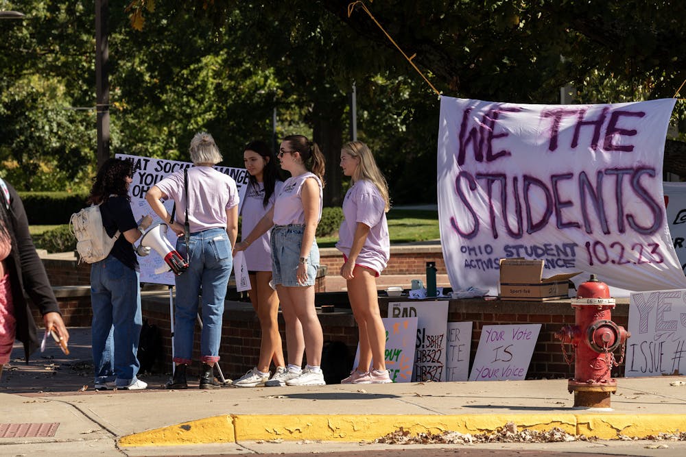 Olivia Gallo and Clara Conover, who led OSAA&#x27;s Day of Action,﻿ stood at the corner outside Shriver to vocalize student activism.