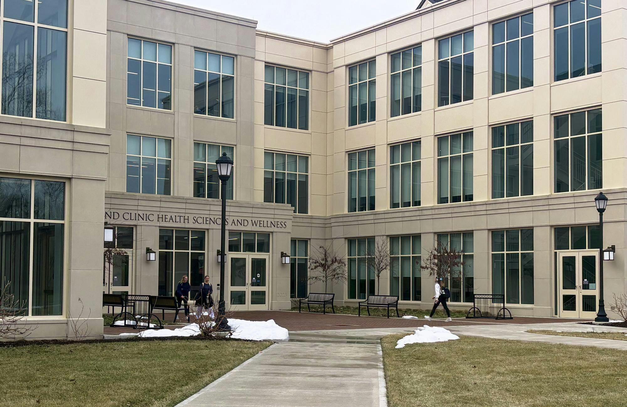 Student walks into the Cleveland Clinic Health Sciences and Wellness building, which houses the Physician Assistant Studies program.