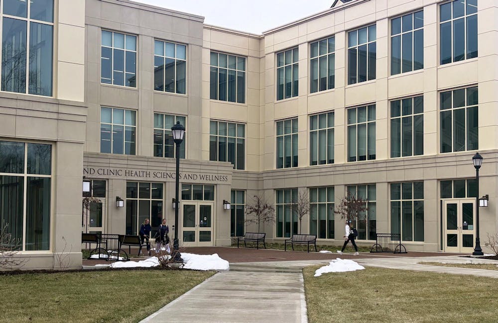 Student walks into the Cleveland Clinic Health Sciences and Wellness building, which houses the Physician Assistant Studies program.