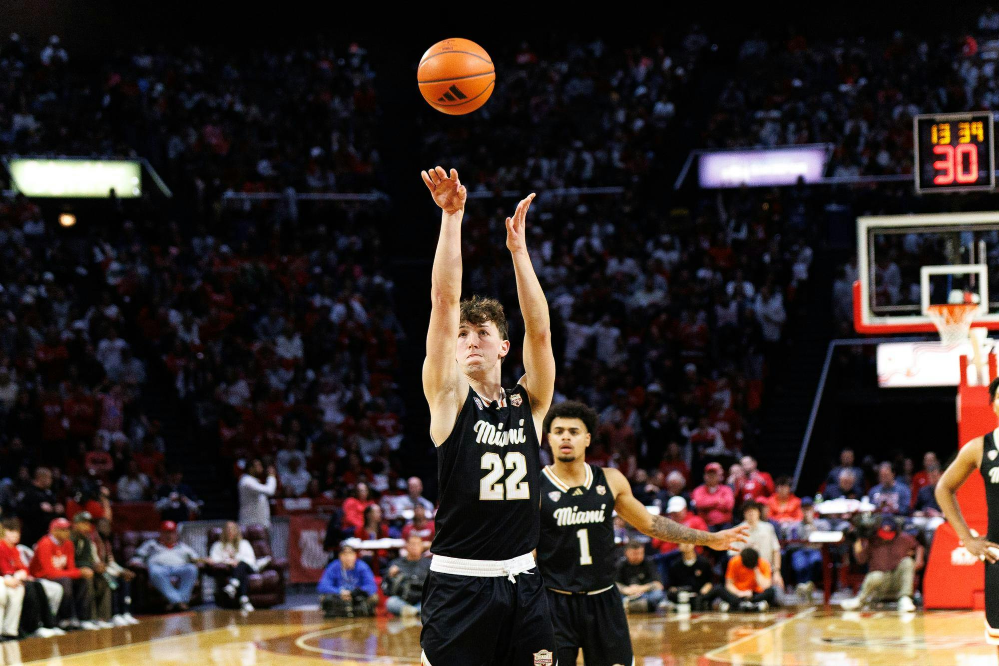 Sophomore guard Brant Byers shoots a 3-pointer in match against the Bowling Green State University Falcons. Freshman guard Trey Perry watches from behind.