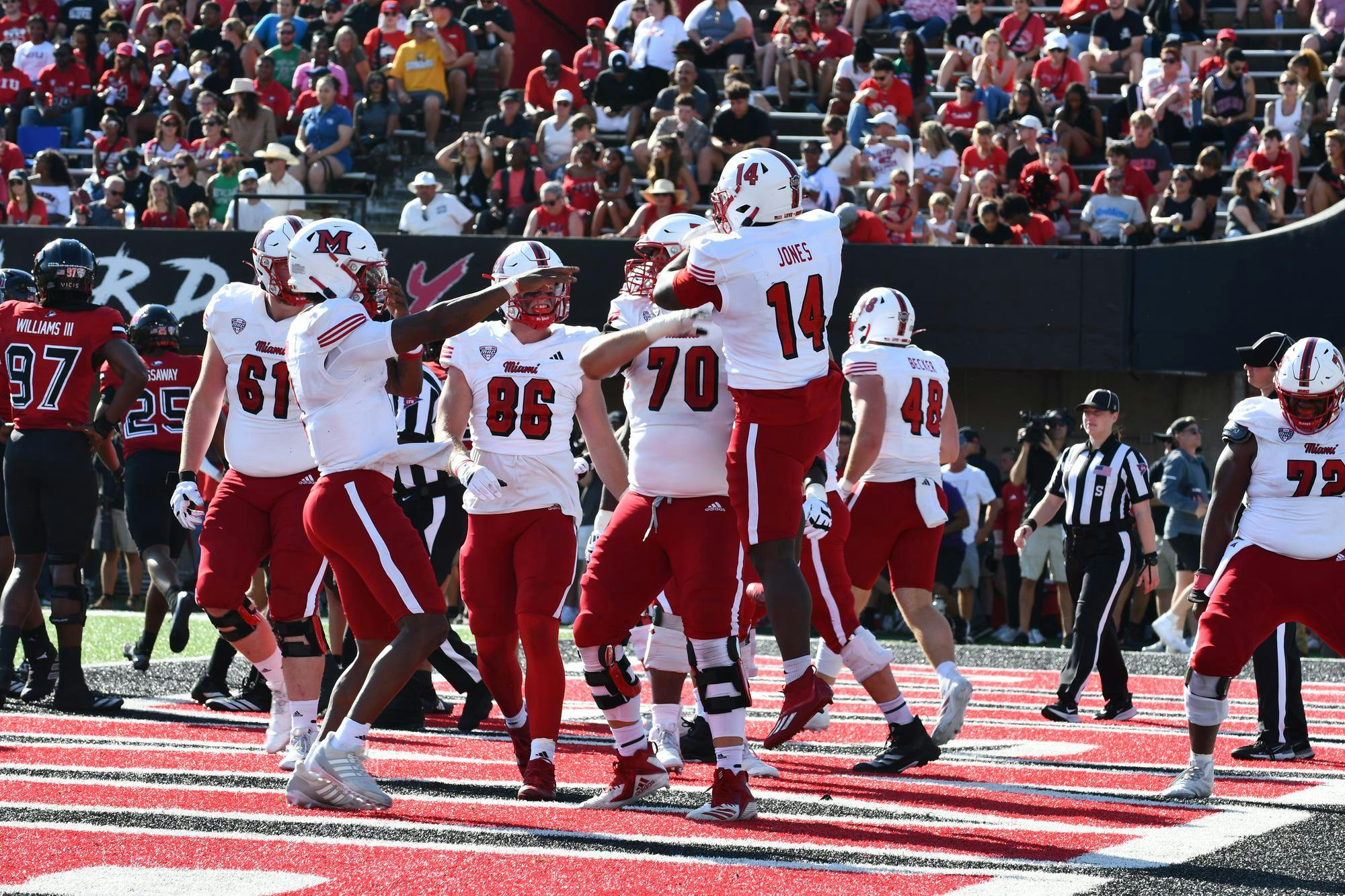 The Miami football team celebrates redshirt freshman running back D’Shawntae Jones' touchdown in the second quarter against Northern Illinois on Oct. 4