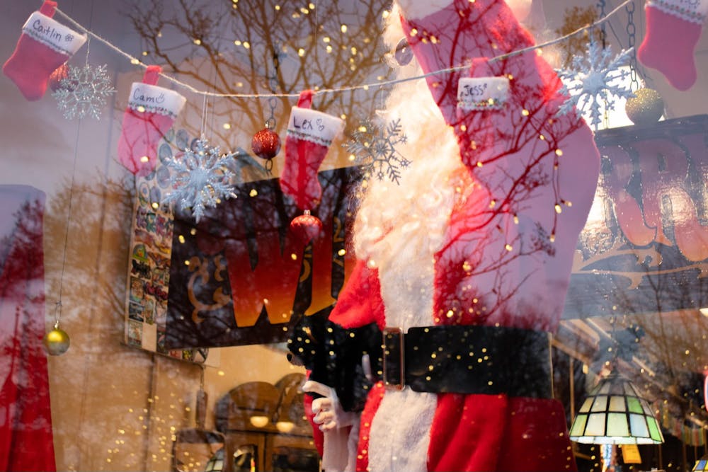 Wild Berry&#x27;s shop window is decked out with stockings and a fake Santa Claus.