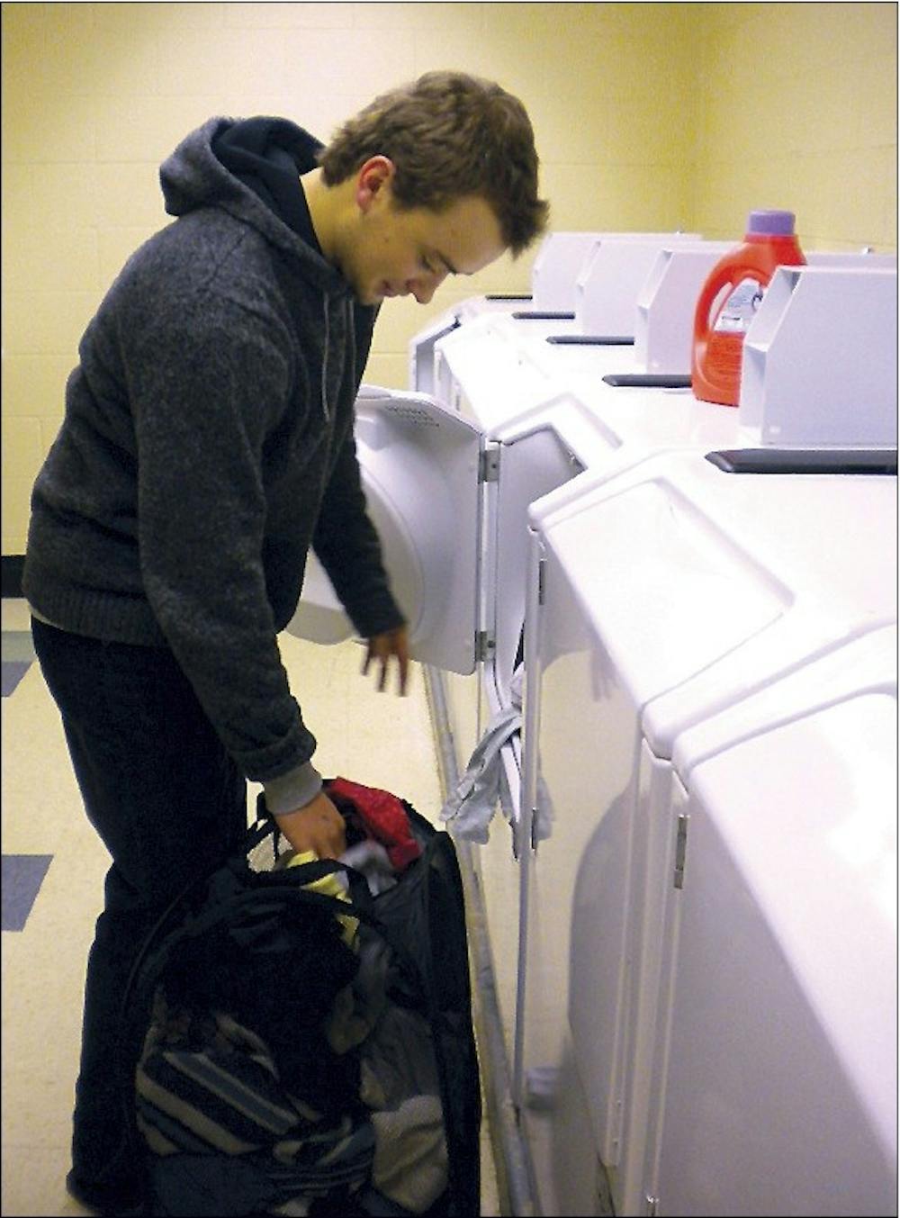 Mack Converse, a first-year, does his laundry for free in Stanton Hall while the eSuds system is down.