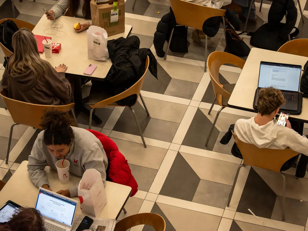 Students sit with their electronics in Armstrong Student Center.
