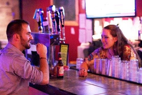 Senior Sarah Hess serves junior Jake Menker at Hole in the Wall Bar.
