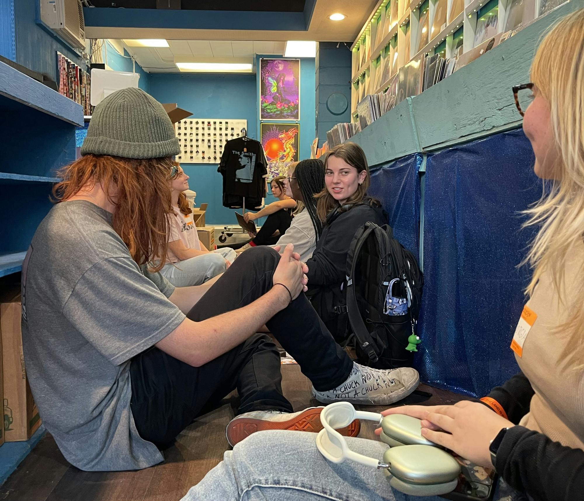 Attendees sit on the floor of Black Plastic Records in silence while they listen to Mitski’s new album.