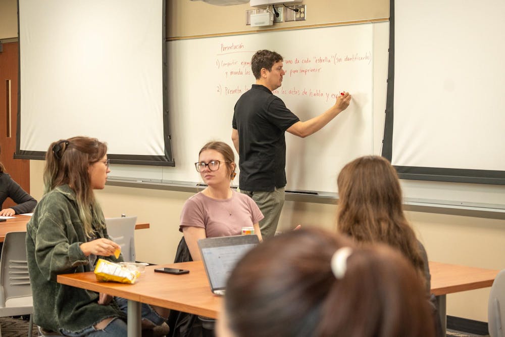 <p>Students collaborate with one another in a Spanish Linguistics class in Kreger 222</p>