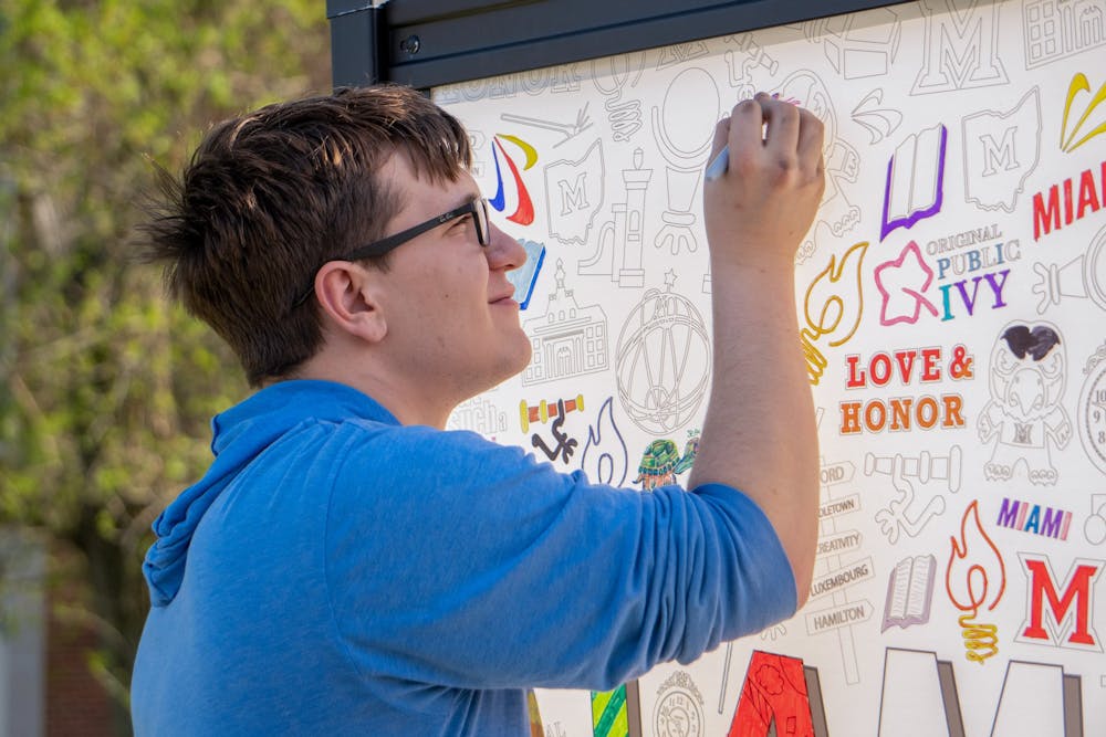 First-year Michael colors a picture of Swoop on the doodle wall.