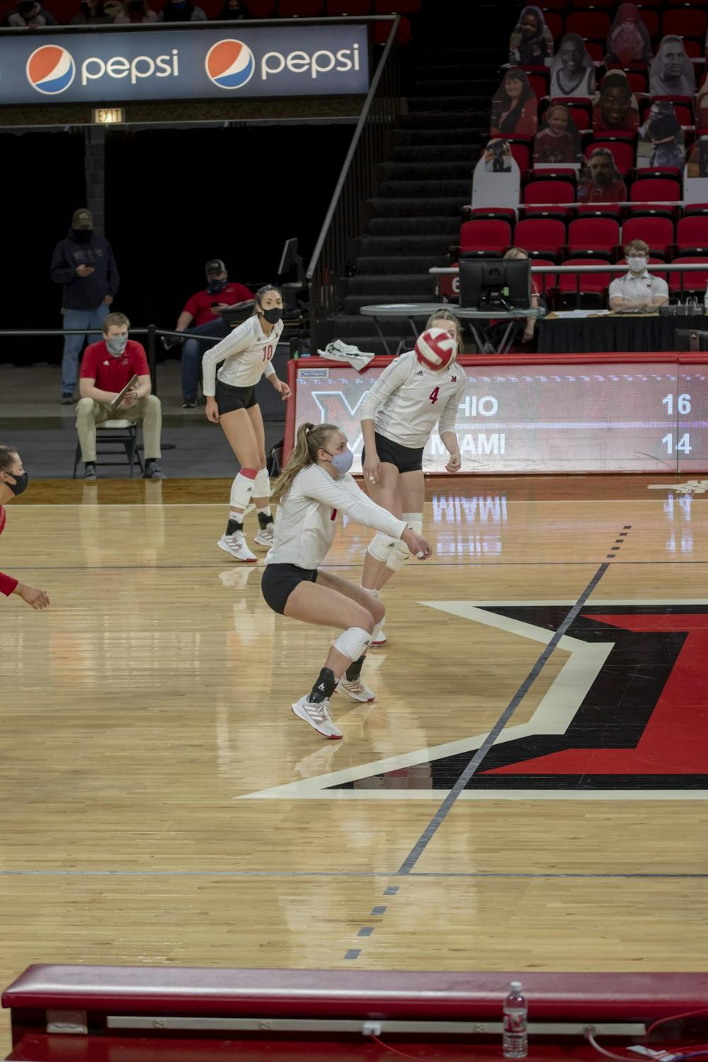Junior libero Jaquelyn Krumnauer (middle) executes a bump in a spring 2021 match against Ohio University.
