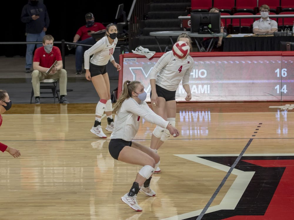 Junior libero Jaquelyn Krumnauer (middle) executes a bump in a spring 2021 match against Ohio University.
