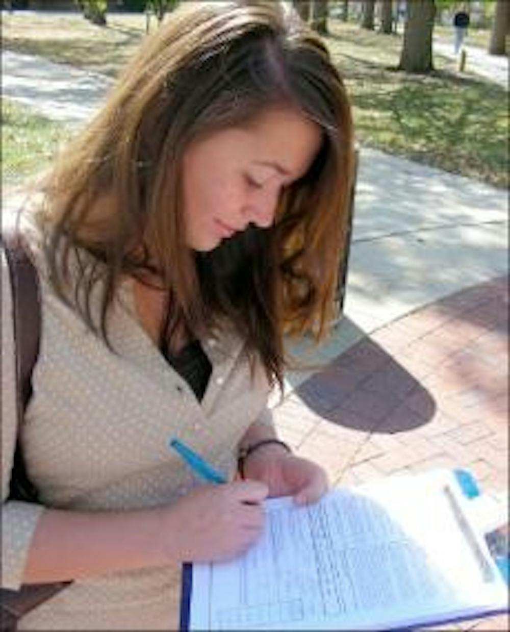 Miami senior Jessica Dillree registers for the November election Thursday at the hub.