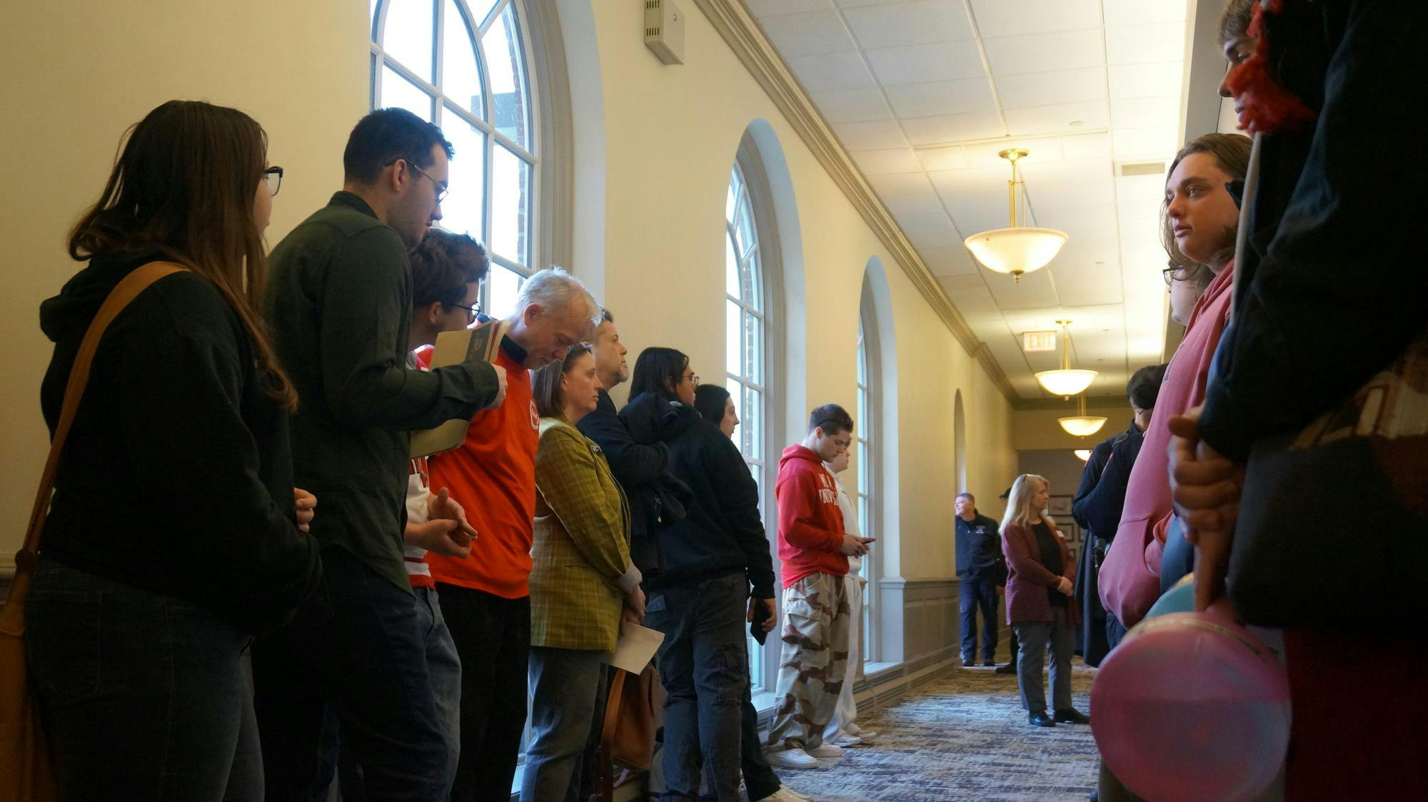 Students and faculty stand outside the Miami University Board of Trustees meeting on Feb. 27.