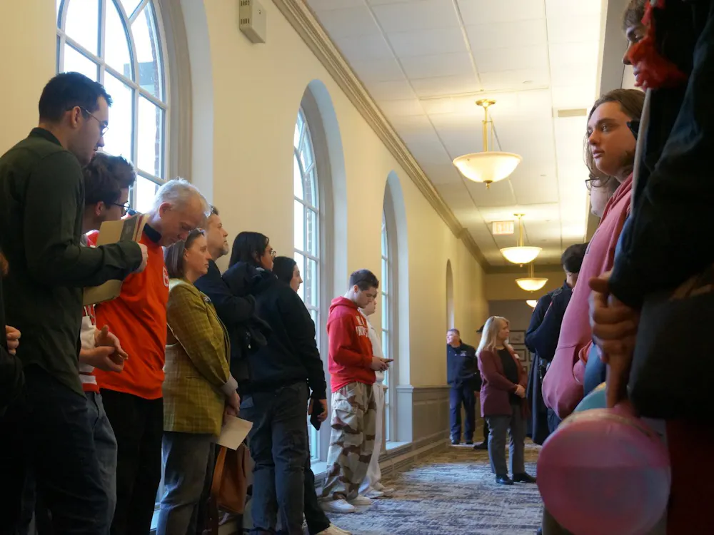 Students and faculty stand outside the Miami University Board of Trustees meeting on Feb. 27.