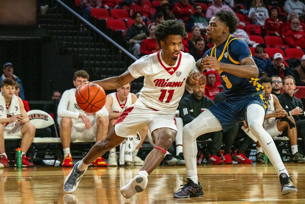 Sophomore guard Mekhi Cooper dribbling against a Toledo player on Feb. 11 at Millett Hall