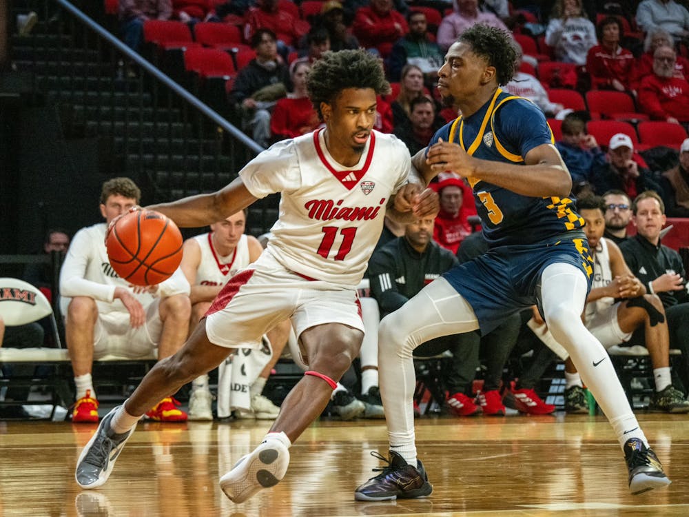 Sophomore guard Mekhi Cooper dribbling against a Toledo player on Feb. 11 at Millett Hall