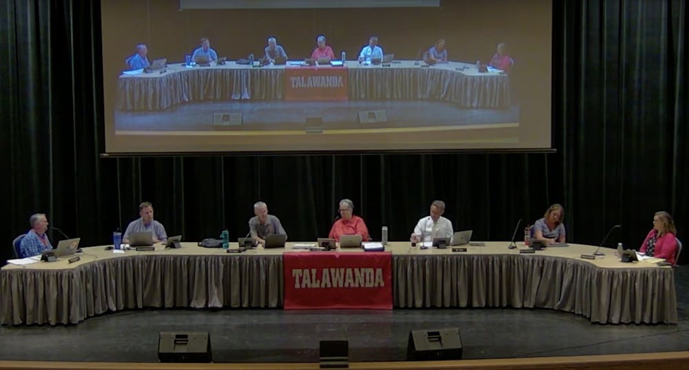 Talawanda School Board members meet to discuss administrator salary models and address harassment towards members. 