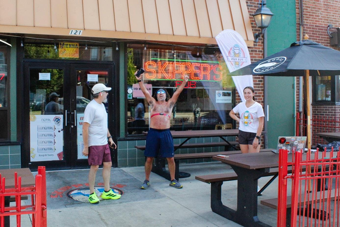 Bill Levenderis (middle), Savannah Perry (right) and fellow runner (left) convene at Skipper’s Pub at 6:15 p.m. after their run on Tuesday, Sept. 2.