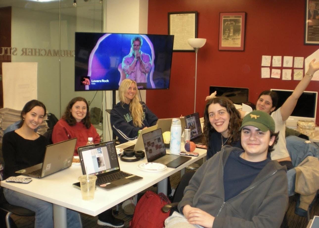 Jayson Brake (far right) works with the design team on a production night.