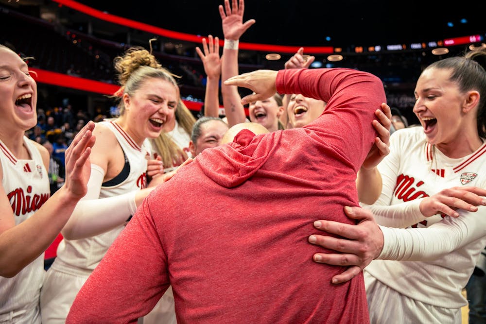 The Miami women's basketball team celebrates at Rocket Mortgage Arena after capturing the MAC championship against Toledo on March 14 in Cleveland