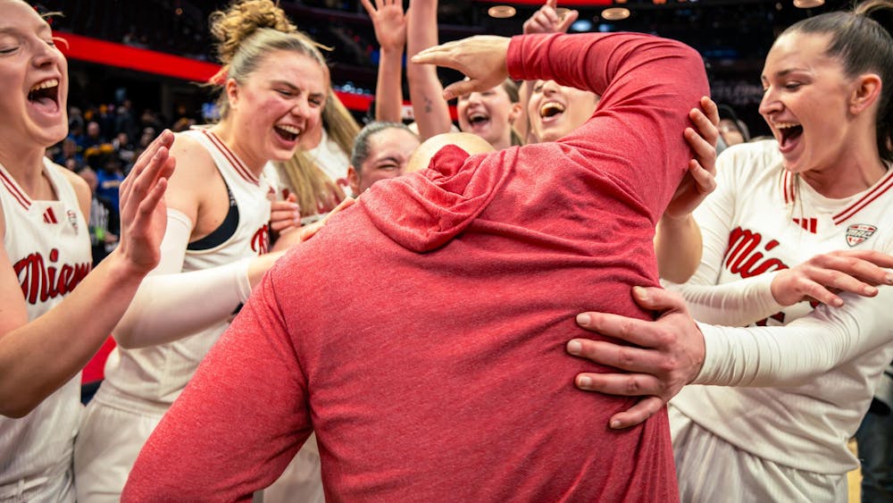 The Miami women's basketball team celebrates at Rocket Mortgage Arena after capturing the MAC championship against Toledo on March 14 in Cleveland