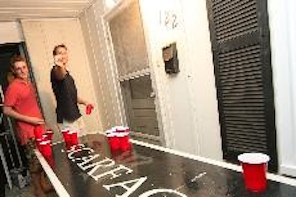 Seniors Steve O'Connell and Chaz Nichols play beer pong at their Church Street residence. If they leave the table outside the students could face a $250 fine.