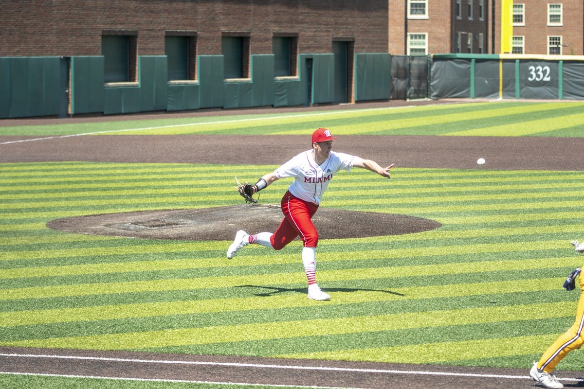 A Miami infielder flips the ball to first base for an out