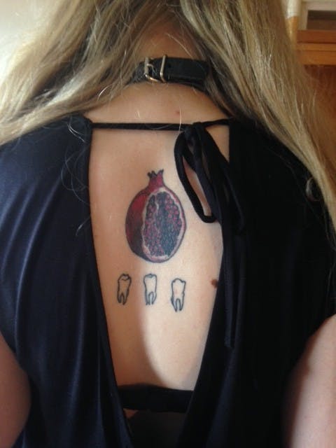 Hannah calls the tattoos her "devotional ink." The pomegranate references the Greek tale of Persephone and the teeth are related to Lucifer. | Photo by Phoebe Myers