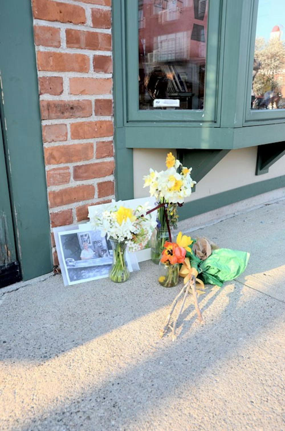 Flowers and paintings were placed outside Bill’s Art Store on  Wednesday after local residents learned of owner Bill Berry’s death.