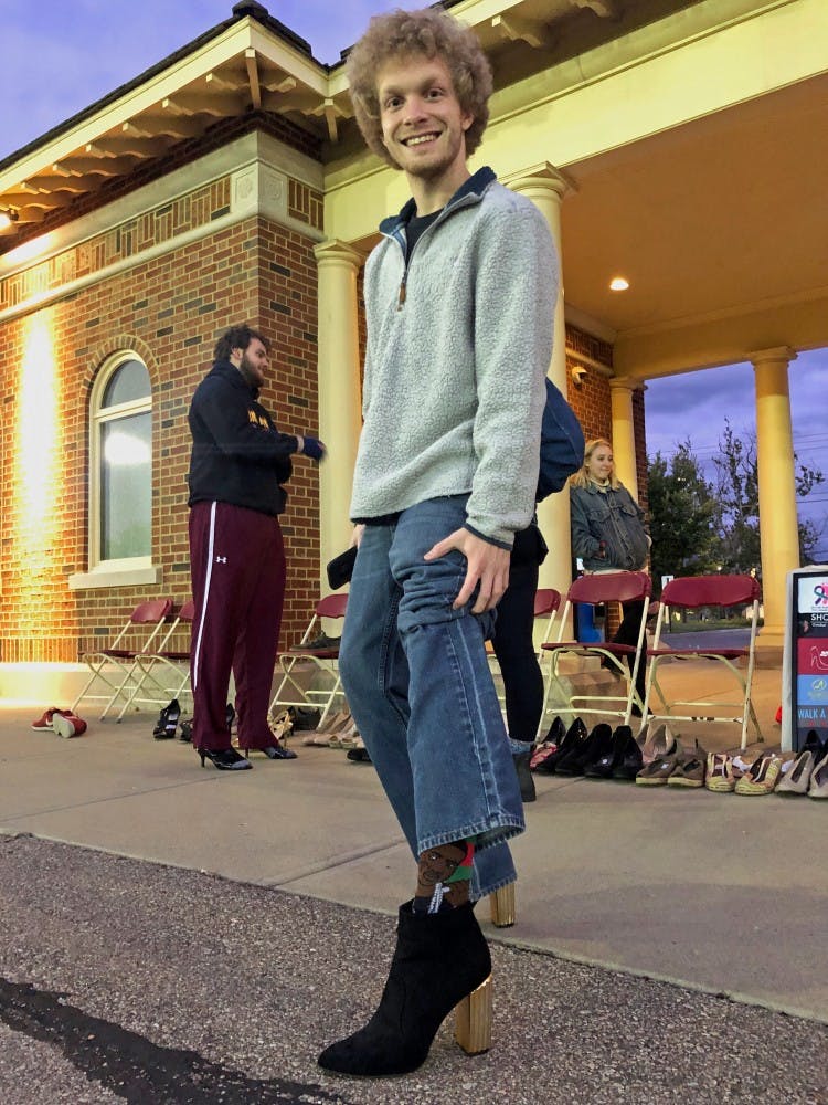 Students walk around Cook Field in high heels to raise awareness for sexual assault survivors. 