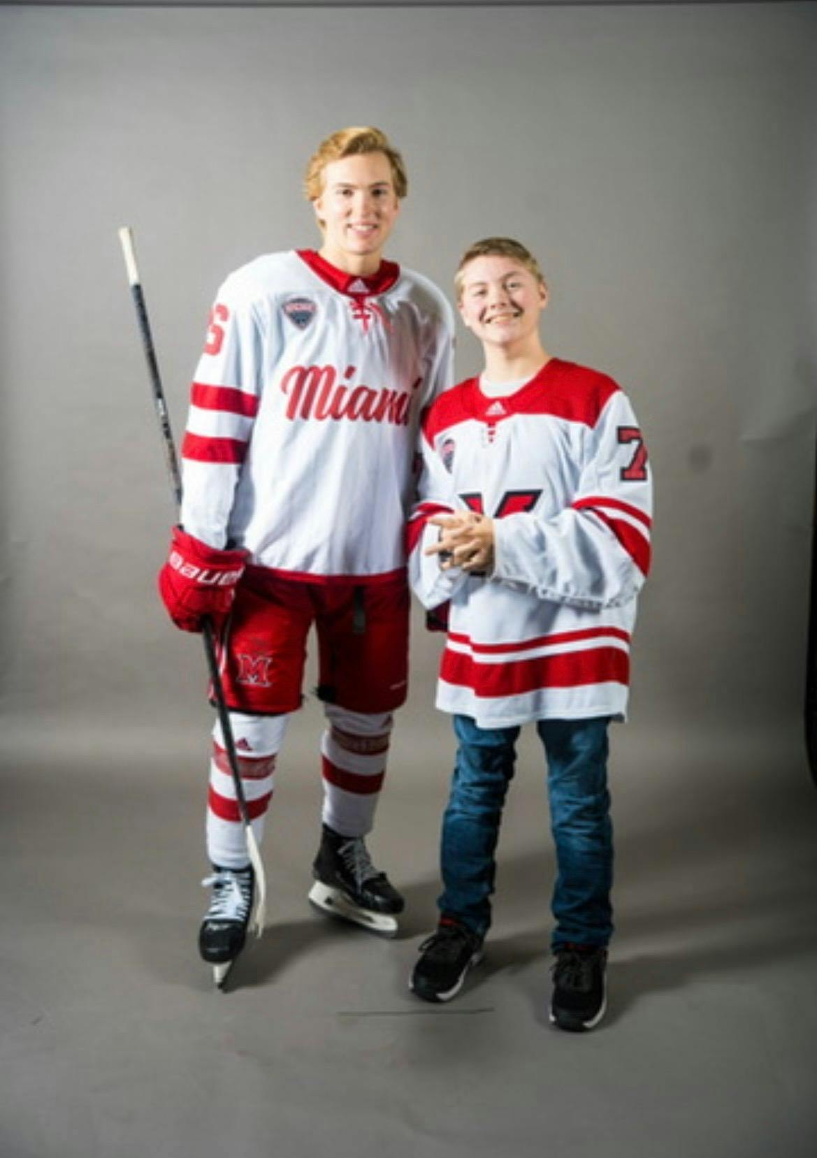 Blake Mesenburg (left) and Liam Jergenson (right) pose for a picture wearing Miami University hockey gear.