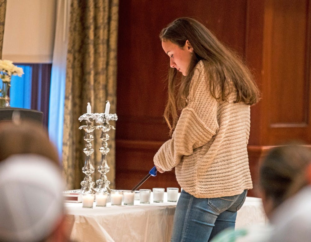 Students lit 11 candles for the victims of the Tree of Life shooting.