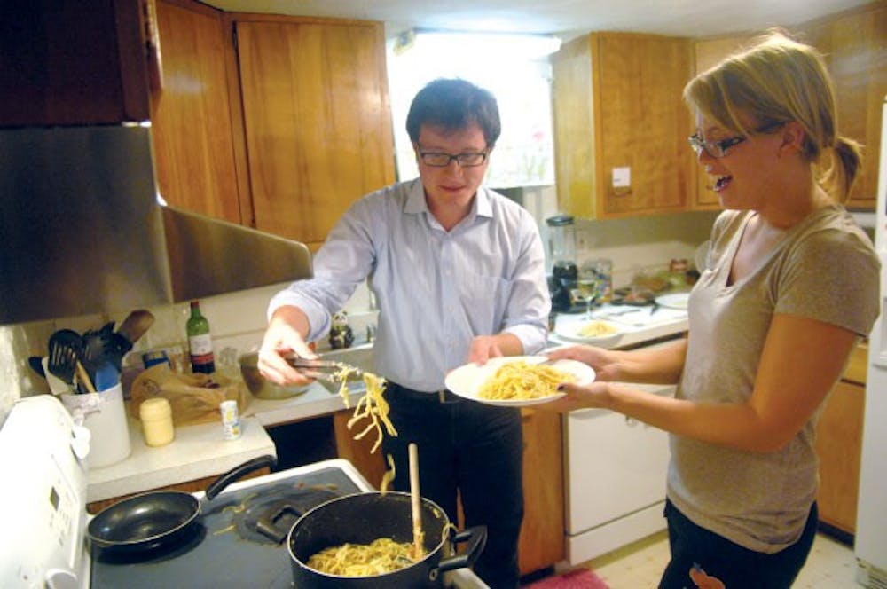 International student Marco Formentini serves home-cooked Italian pasta to senior Jess Mitchell Wednesday evening.