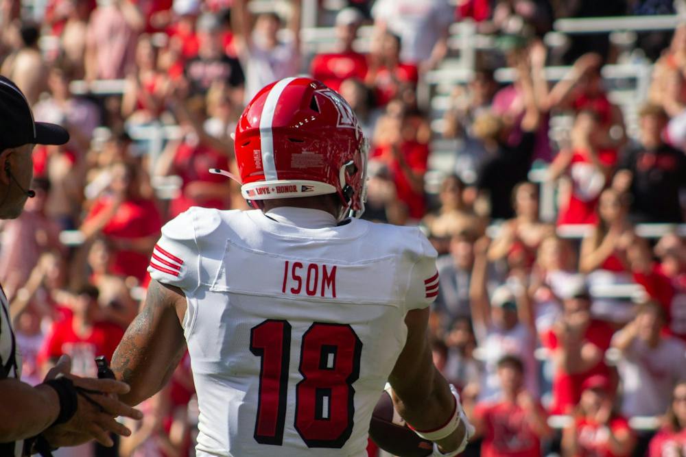 Wide receiver Braylon Isom gets up after catching ball and faces fans in Battle of the Bell.