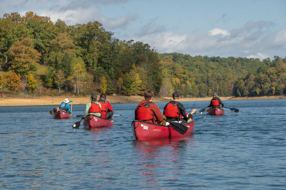 Students and staff from Miami University explore Laurel Lake in canoes during fall break.