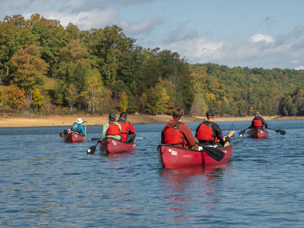 Students and staff from Miami University explore Laurel Lake in canoes during fall break.