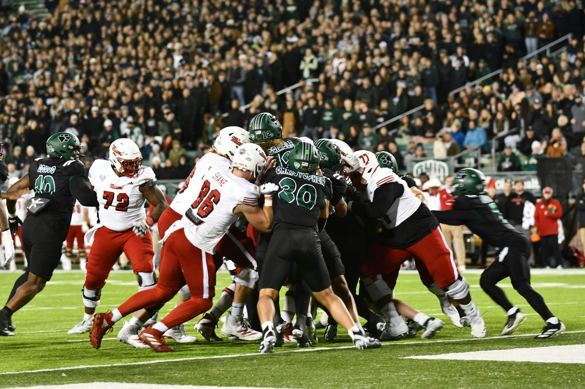 Miami's offense blocks against the OU's defensive line in the second quarter at Peden Stadium on Nov. 4
