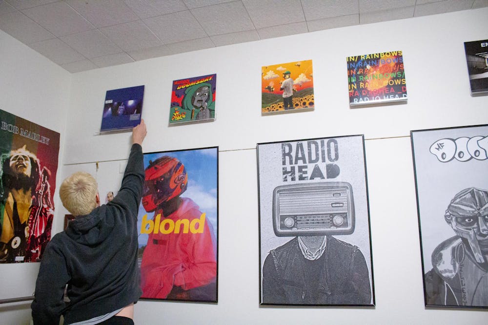 <p>Sami Lacksonen adding the Dummy album by Portishead to his wall collection</p>