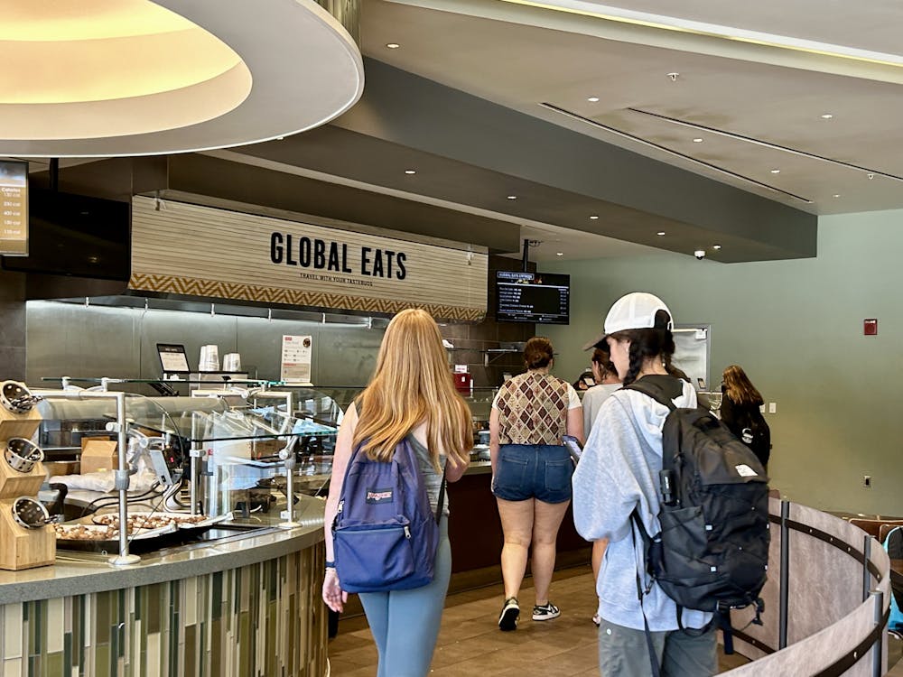 <p>Students wander through the &quot;Global Eats&quot; section in Maple Dining Commons. </p>