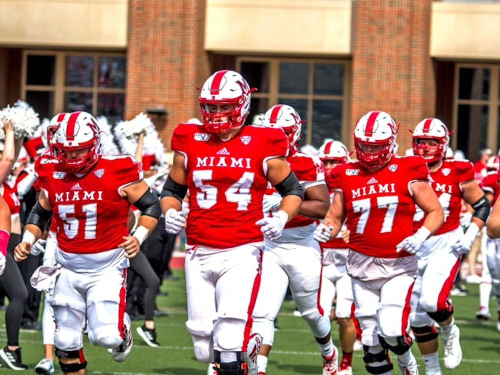 Then-redshirt junior offensive lineman Tommy Doyle (No. 54) leads the RedHawks onto the Yager Stadium turf before Miami&#x27;s Sept. 28 showdown with Buffalo.