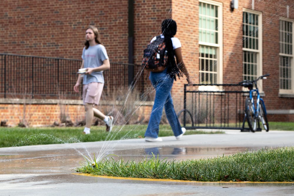Students pass a soaked sidewalk outside Armstrong Student Center.﻿