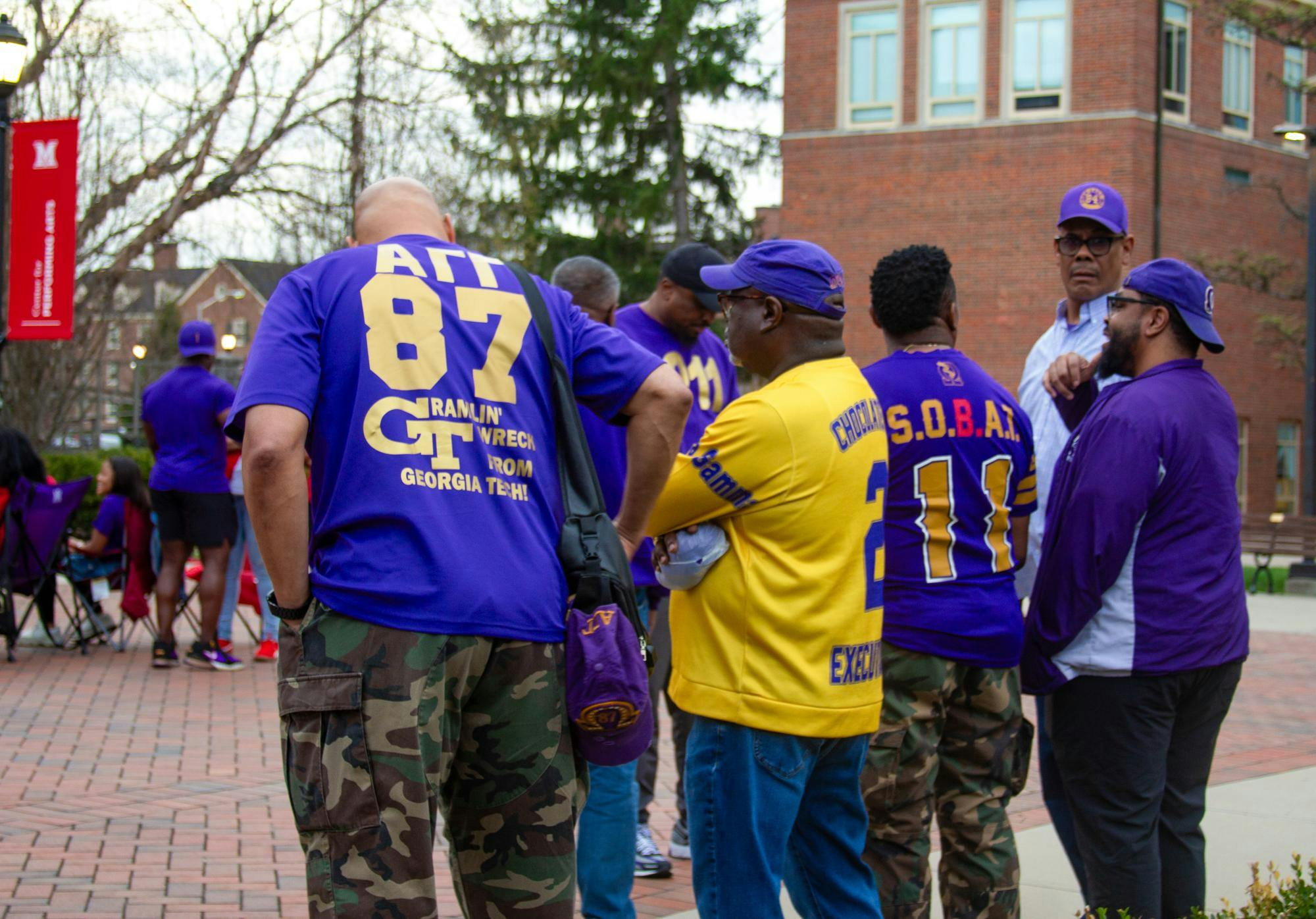 Older members of Omega Phi Psi wait patiently for the new member show in the Fine Arts Plaza
