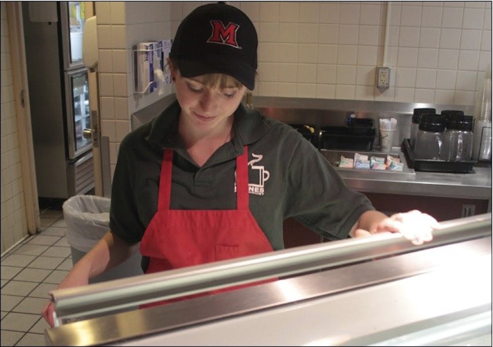 Tuffy’s employee and first-year student Lauren Moore serves ice cream Thursday.