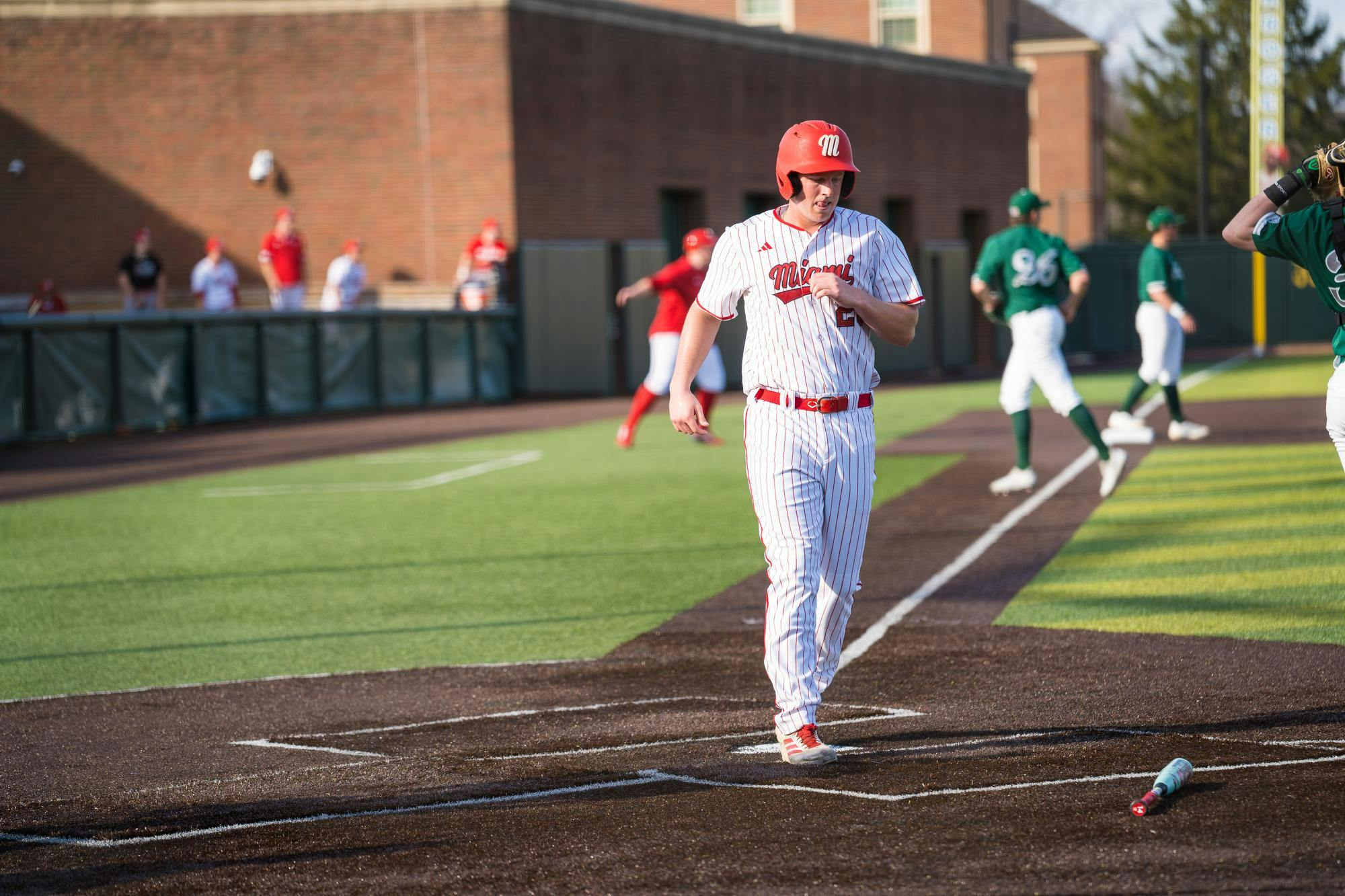 Redshirt junior outfielder Tommy Harrison steps on home plate in game against Eastern Michigan on March 6. 