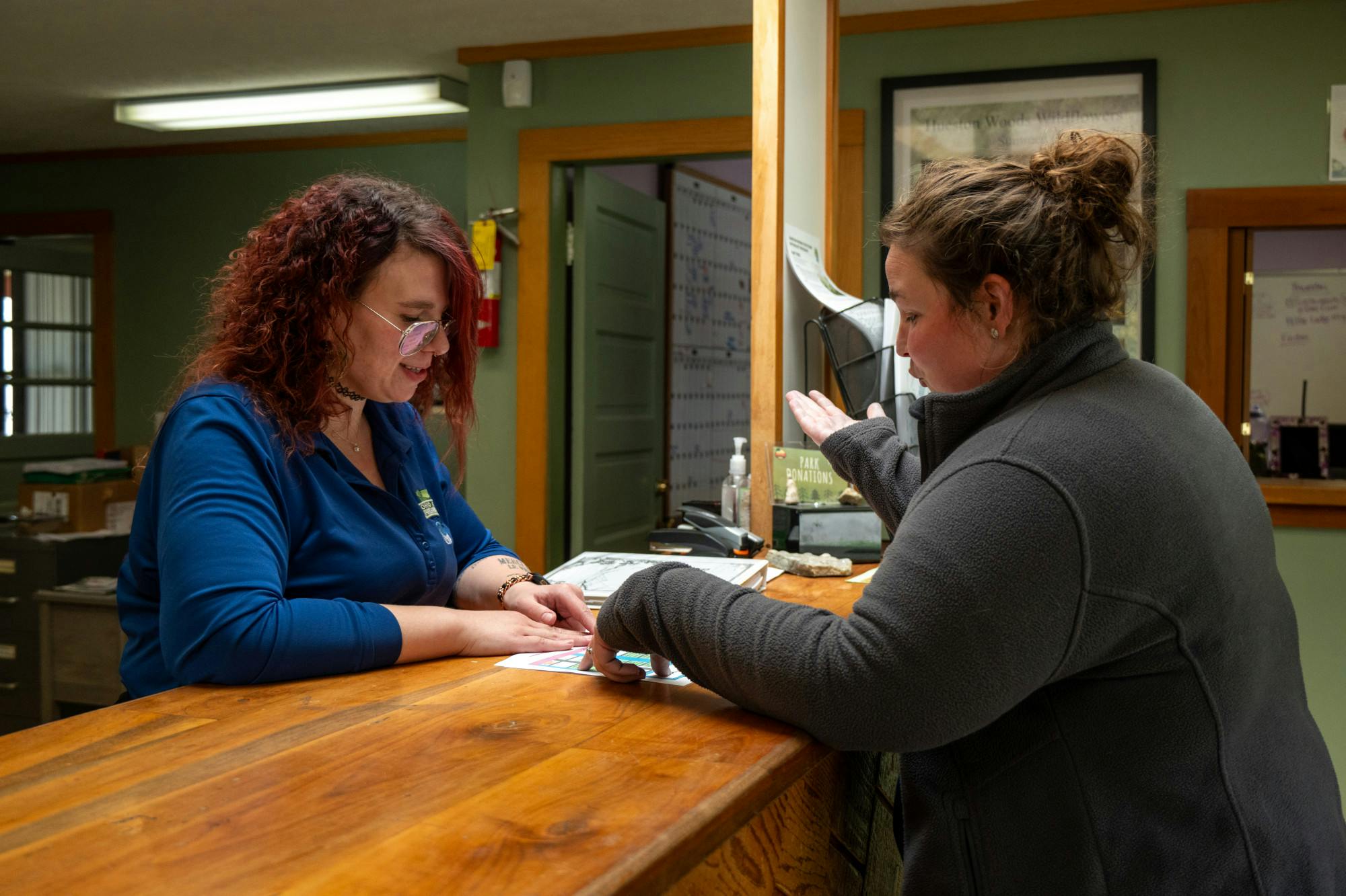Hueston Woods worker assists a customer at the front desk