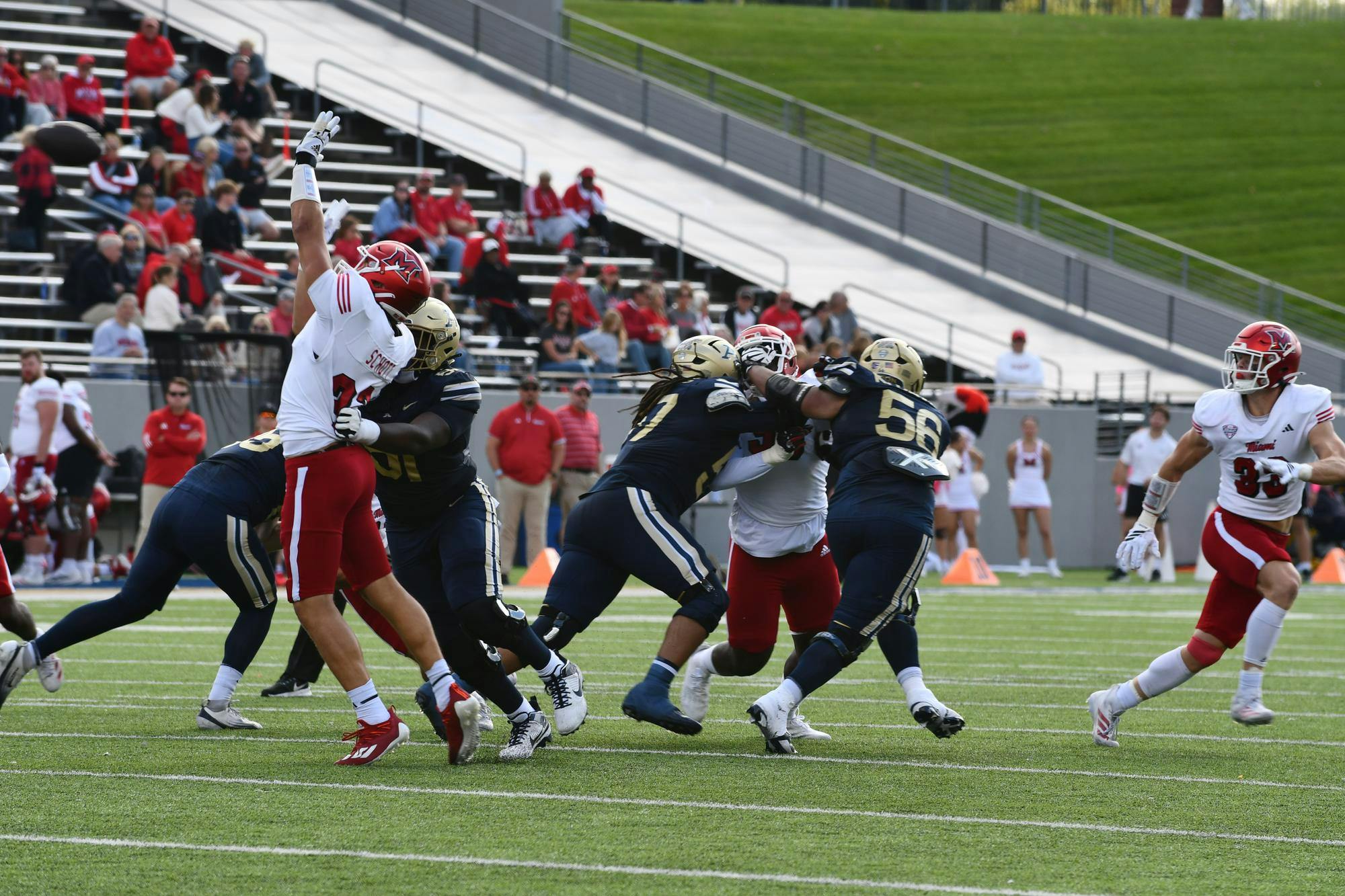 Miami's defense reaches for a deflected pass against Akron on Oct. 11