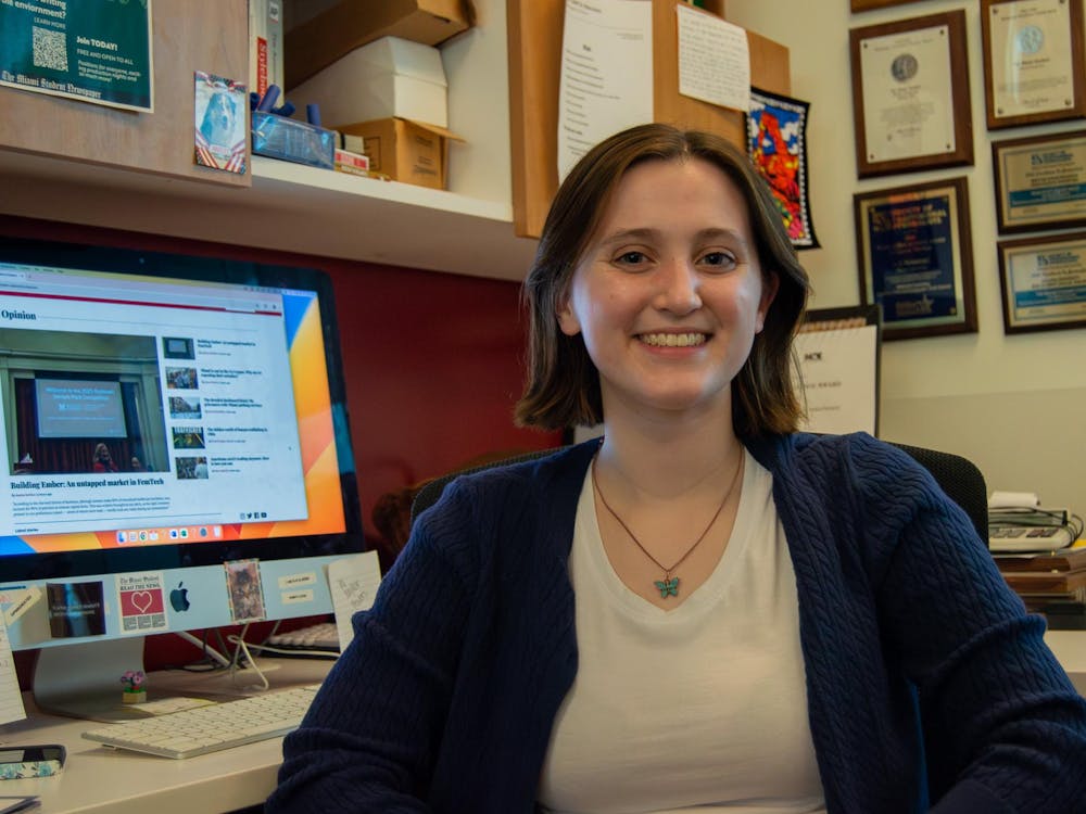 Taylor Powers, Opinion Editor, sits at her desk.
