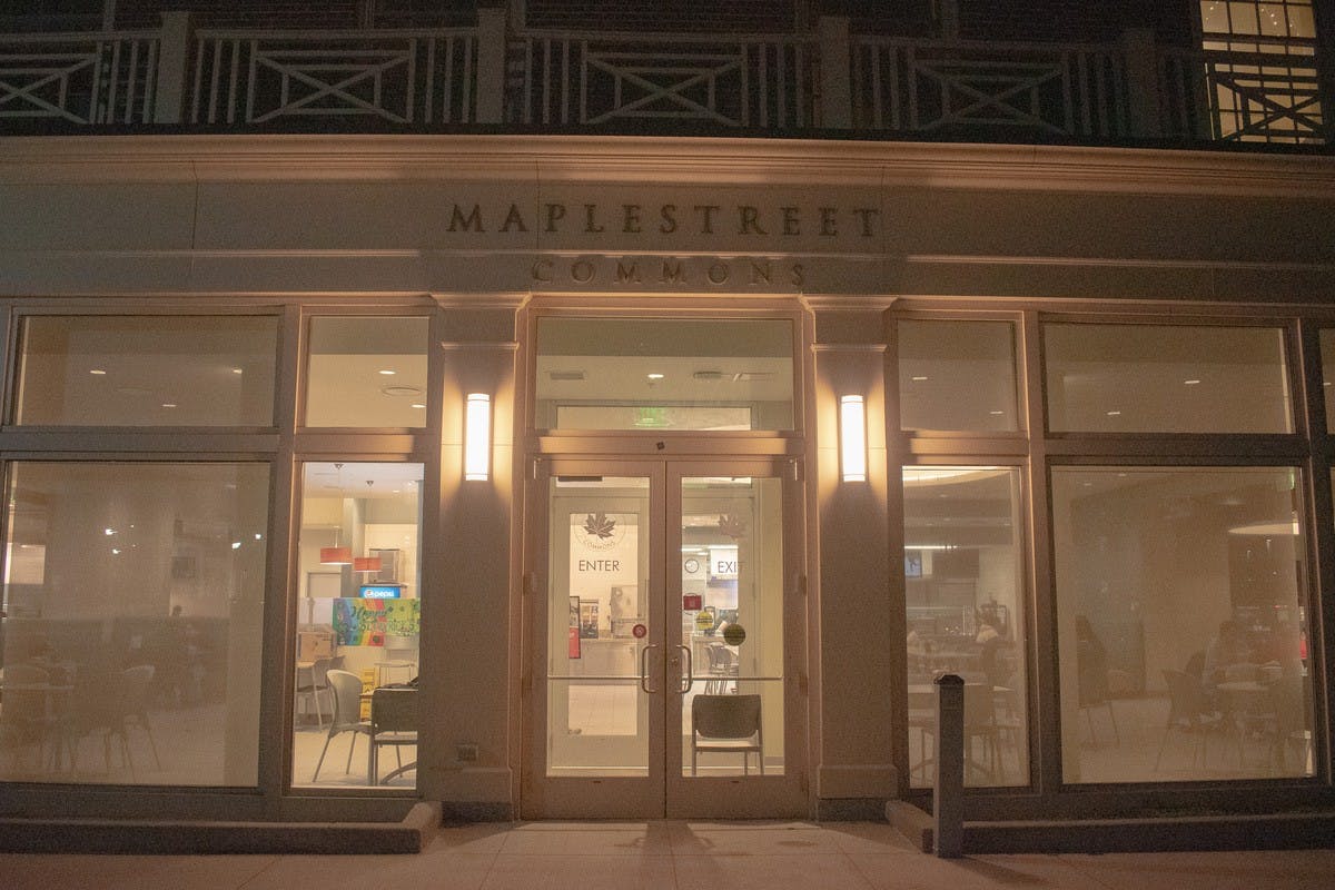 A handful of students finish up their meals inside a closed Maple Street Dining Hall.