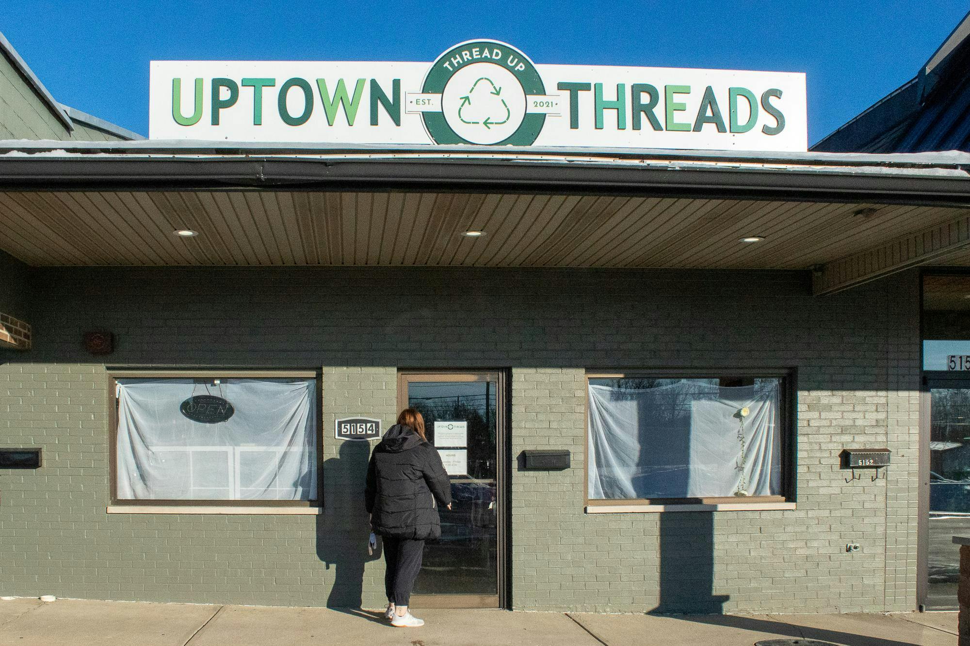 Emily Clark opens the door to Uptown Threads, now located at 5154 College Corner Pike, Oxford OH.