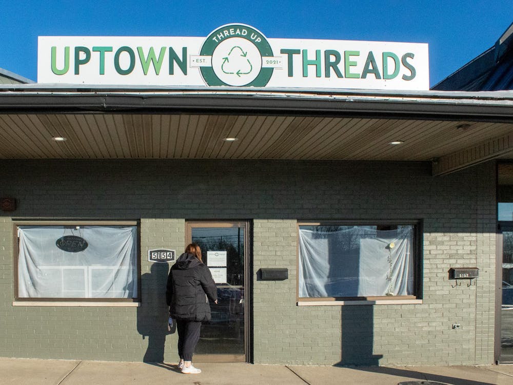 Emily Clark opens the door to Uptown Threads, now located at 5154 College Corner Pike, Oxford OH.