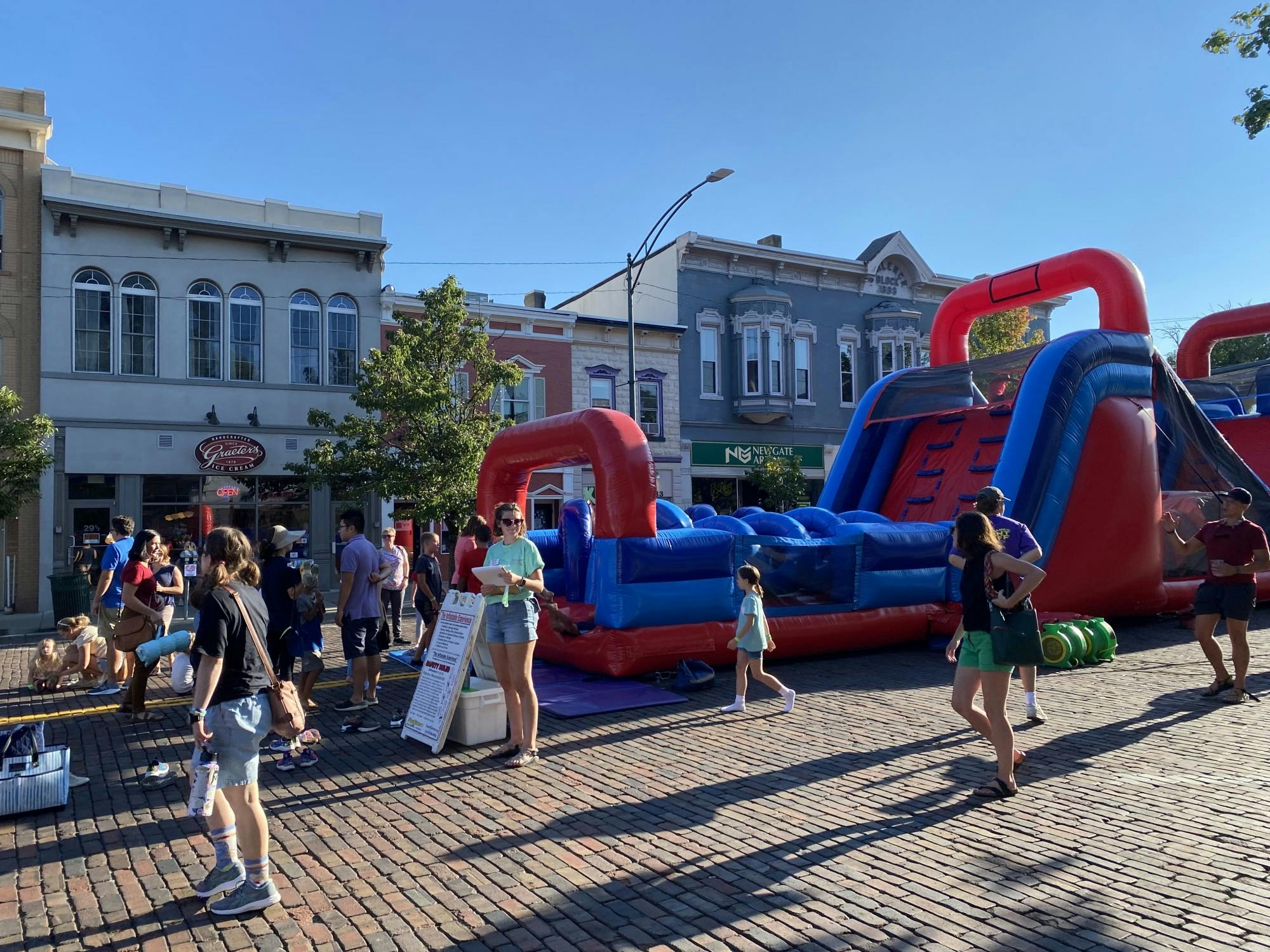 Many kids and college students alike eagerly await their turn on the inflatable obstacle course.